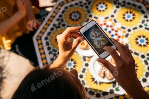 Preview: University student taking pictures of moroccan food with smartphone