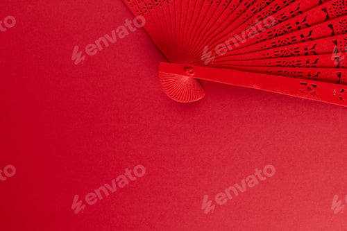 Preview: Composition of traditional chinese fan on red background