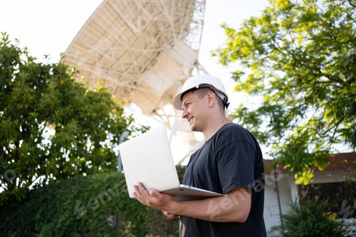 Preview: Engineer looking earth based astronomical radio telescope