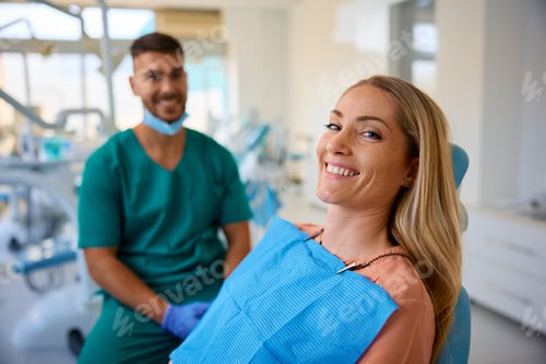 Preview: Happy woman during her visit at the dentist looking at camera.