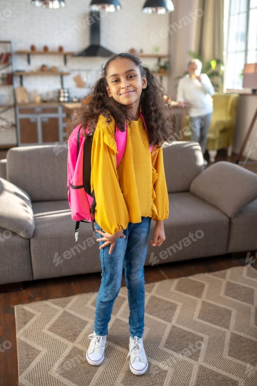 Preview: Cute dark-skinned girl with curly hair posing for the photo