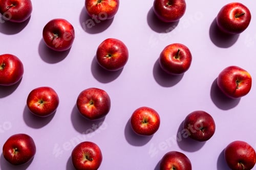Preview: Many red apples on colored background, top view. Autumn pattern with fresh apple above view