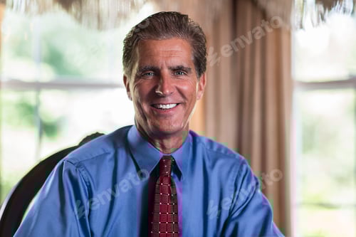 Preview: Portrait of mature businessman at home