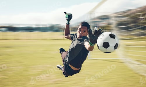 Preview: Soccer, sports and goalkeeper with a man saving a shot, goal or score during a game on a grass pitc