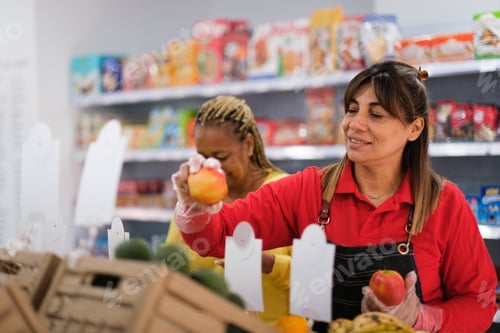 Preview: Senior woman selecting fruit in the market