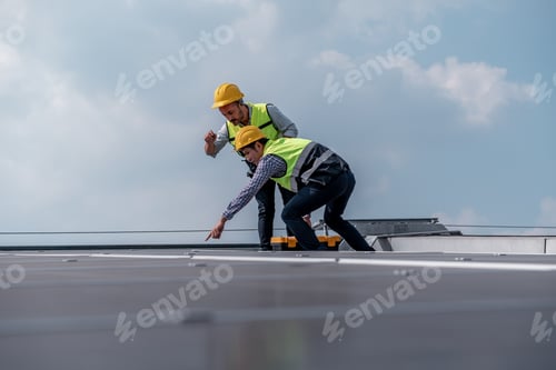Preview: Engineers walking on roof inspect and check solar cell panel by hold equipment box and radio communi