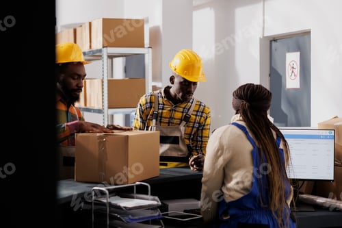 Preview: Postal worker examining packed parcel before delivery at checkout
