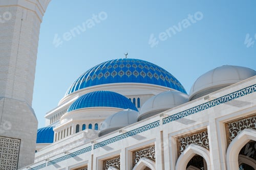 Preview: Exterior of a beautiful mosque with a blue dome and a symbol of the Islamic religion, close-up