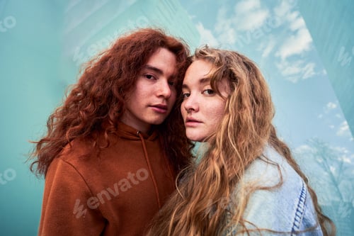 Preview: Young couple with long hair posing together outdoors