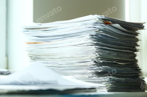Preview: Stacks of documents on desk in office