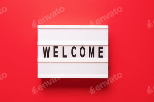 Preview: Lightbox with word welcome on red background, top view. Space for text