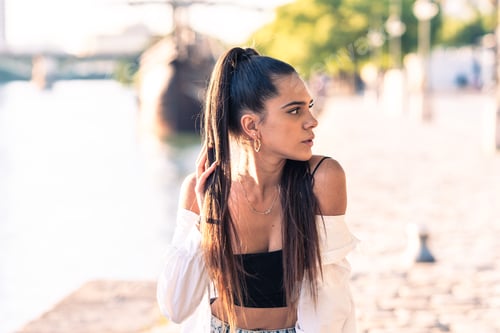 Preview: Stylish Woman with Long Hair Posing Outdoors