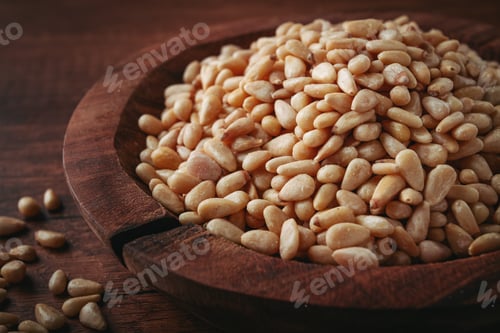 Preview: peeled pine nuts, in a wooden bowl, on a wooden table, close-up, no people,