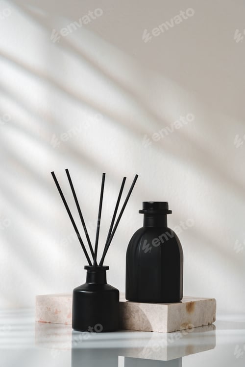 Preview: Elegant Aroma Diffuser With Black Reeds on a Marble Stand in Soft Daylight