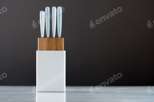 Preview: kitchen knife set in white holder on the kitchen table, close-up