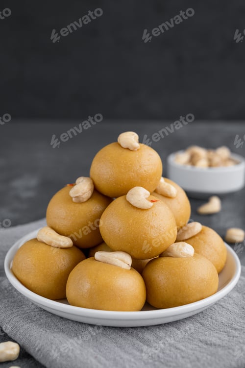Preview: Indian sweets Besan Laddu or Laddoo on a plate. Roasted chickpea flour with ghee and sugar
