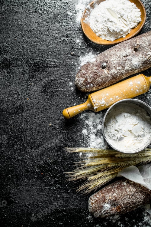 Preview: Fragrant rye bread with flour, rolling pin and spikelets.
