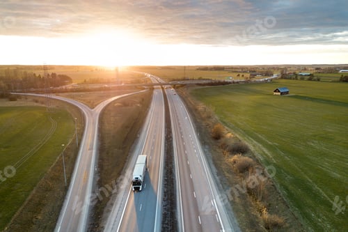Preview: Aerial view of modern highway road intersection at dawn on rural landscape