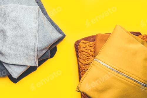 Preview: Stacks of gray and yellow clothing