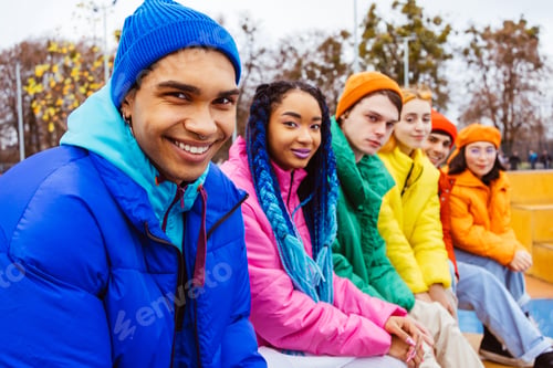 Preview: Multiracial group of young friends meeting outdoors in winter