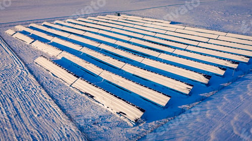 Preview: Snowy solar panels in sunny winter. Aerial view of Poland