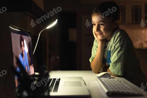 Preview: Beautiful girl studies at the computer at night. Technology and education.