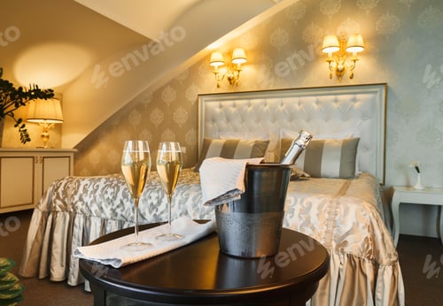 Preview: Two glasses and bottle of champagne in hotel