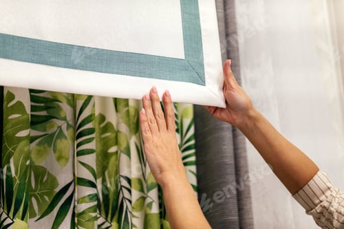 Preview: Female hands choosing fabric for curtain indoor