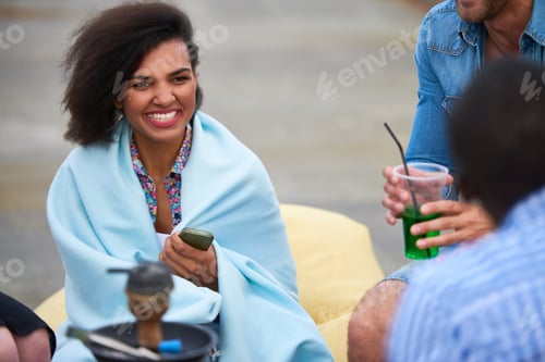 Preview: Young Adult Black Woman Smiling While Socializing Outdoors with Friends