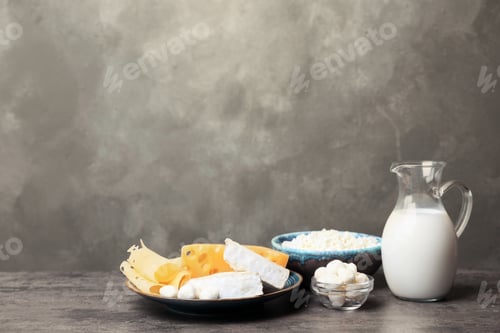 Preview: Different dairy products on table against grey background