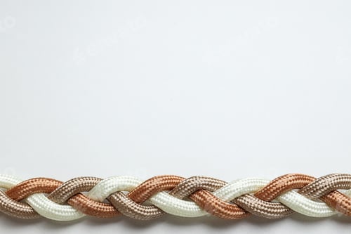 Preview: Braided multicolored ropes on a white background. Concept of unity. Place for text