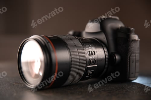 Preview: Close up in focus lens on the body of a professional digital camera.
