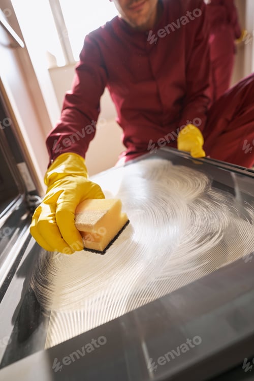 Preview: Professional janitor cleaning piece of kitchen equipment