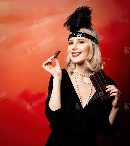 Preview: Beautiful blonde woman in twenties years clothes with chocolate slice