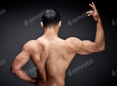 Preview: Who doesnt love a fit back. Shot of an unrecognisable man standing alone and posing in the studio.