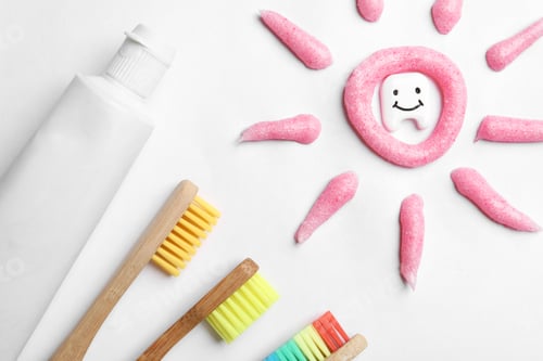 Preview: Composition small plastic tooth and oral care products on white background