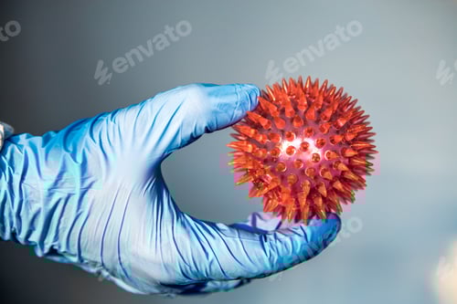 Preview: Gloved Hand Holding Spiked Red Sphere