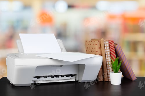 Preview: Compact home printer on desk with books against blurred background