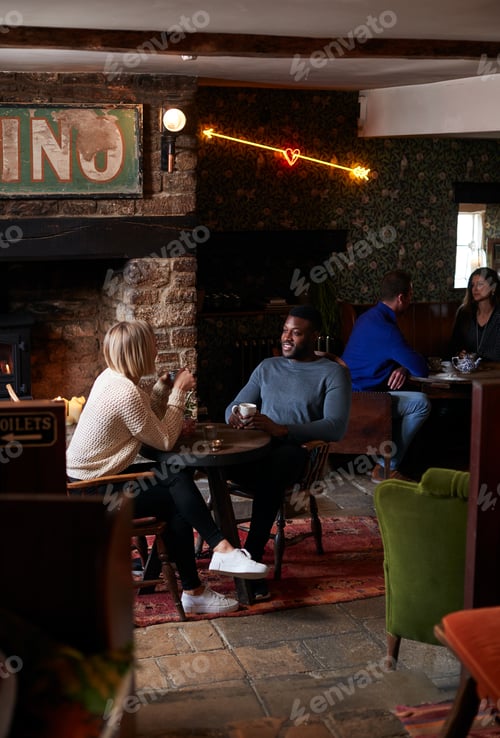 Preview: Couple Sitting At Table Drinking Tea In Traditional English Holiday Hotel