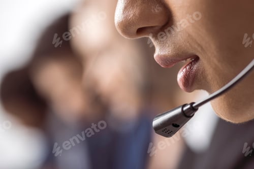 Preview: Cropped shot of call center operator in headset working and talking with client