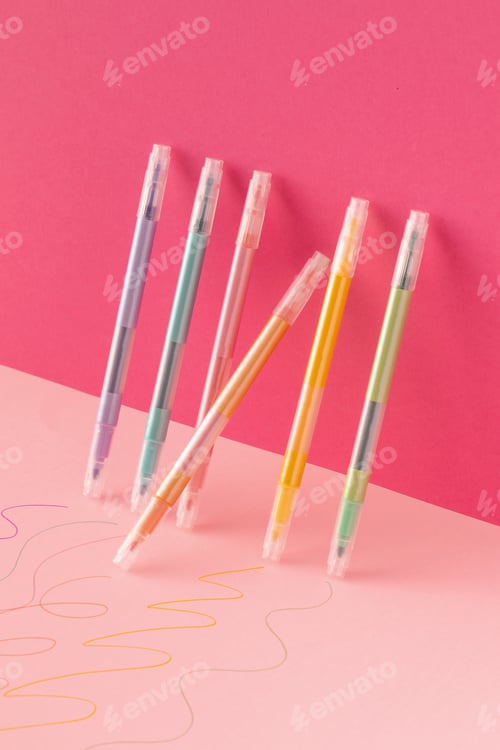 Preview: Colored markers stand against a pink background. Art concept, stationery concept.