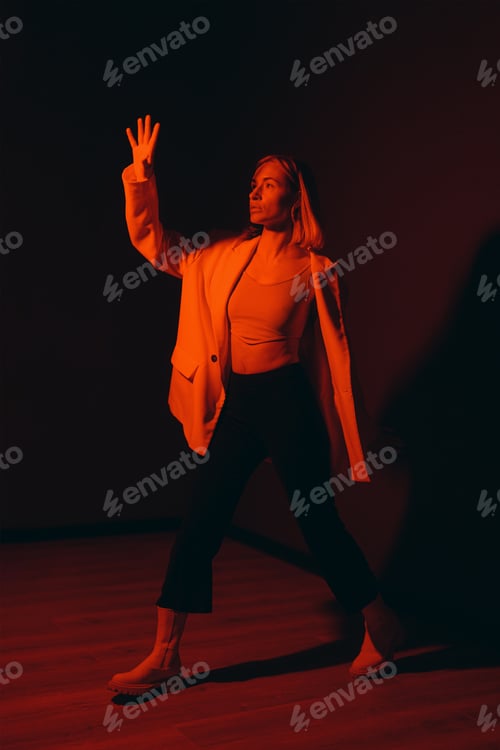 Preview: Dynamic Fashion Pose in Red Spotlight