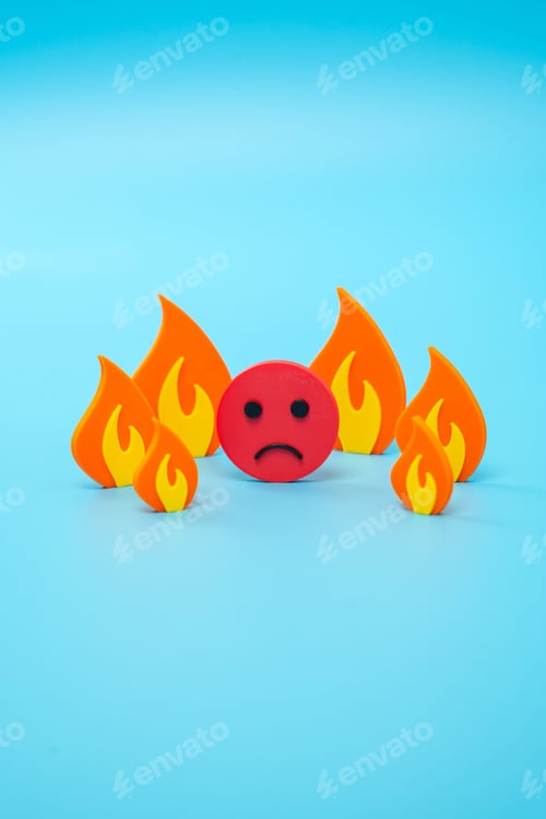 Preview: Sad face surrounded by fire, metaphor. Strong stress and anxious situation. Emotional burnout