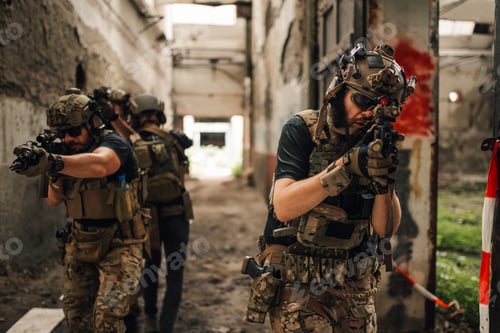 Preview: Few extreme friends playing air soft war simulation game in ruins.