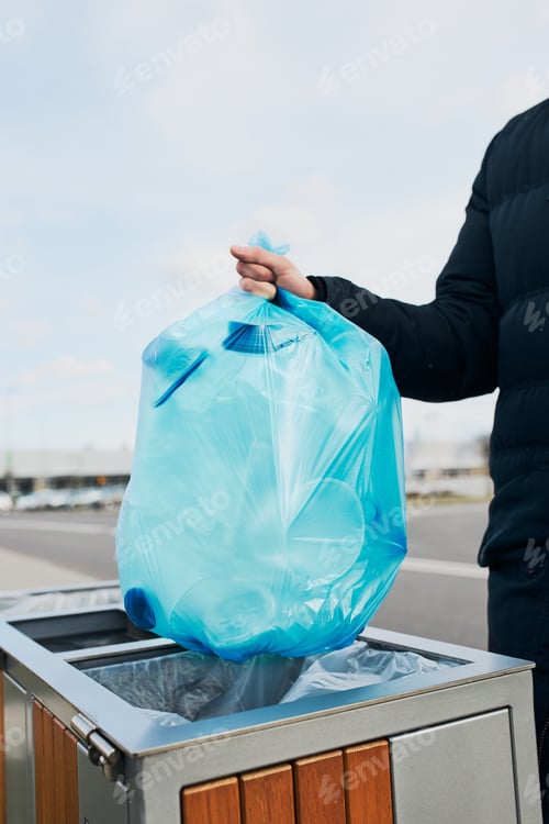 Preview: Man throwing a bag full of plastic waste to trash. Plastic waste to recycling
