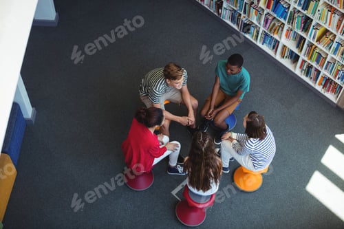 Preview: Students interacting with each other in library