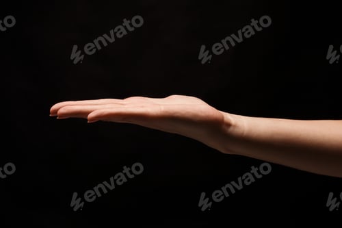 Preview: Woman holding palm open isolated on black