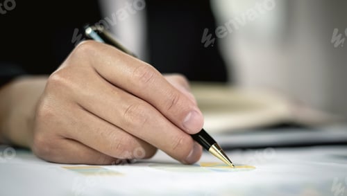 Preview: The businessman hand sits at their desks and calculates financial graphs showing the results