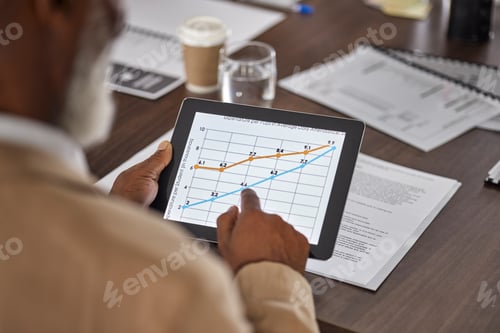 Preview: Hand of man in meeting with tablet, charts and graphs, stats for sales report, data and information