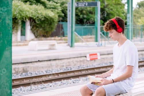 Preview: Teenager Reads Book at Train Station Platform